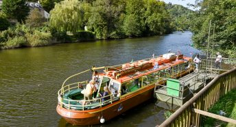 People getting off a small boat after a trip on the River Wye