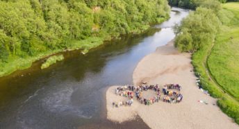 Over 130 people form a human SOS on the riverbank of the Wye